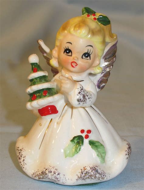 She is trimmed with gold and has red crystal flower centers that add a nice touch. . Josef originals christmas